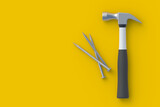 Hammer near nails on yellow background. Construction concept. Home renovation. Tools for repair. Top view. Copy space. 3d render
