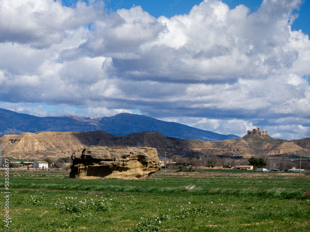 Fototapeta premium Landscape of La Olla de Huesca with views of the castle of Montearagon and sky with clouds. Montearagon Castle 