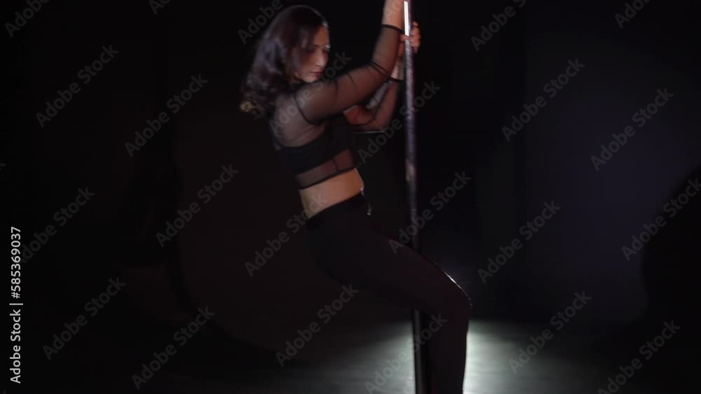 Pole dance. Young beautiful caucasian brunette woman dancer in studio. Pole dance. Young beautiful caucasian brunette woman dancer in studio.