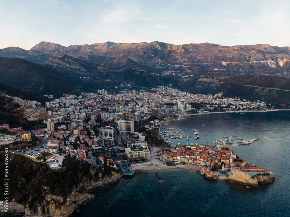 View of Budva - a coastal tourist resort in Montenegro. The old town in the sunset. Shooting from a drone