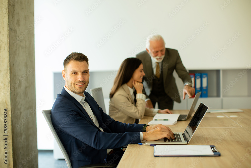 Young business man using laptop computer in the office Young business man using laptop computer in the office