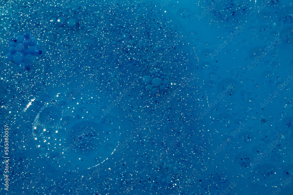 Mixture of water, oil and glitter creating blue metaverse, space background. Mixture of water, oil and glitter creating blue metaverse, space background.