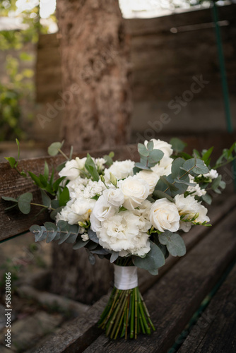 Wedding bouquet of white flowers - ranunculus, freesia, lisianthus.. Wedding. Bride and groom. © Mihai