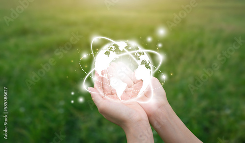 Symbol icon earth in hand young woman on natural green grass. sustainability, ecology and renewable energy for save the world environmental and conservation concept
