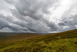 Scenic view of the green landscape at Benwee Head under a Dramatic Sky, County Mayo, Ireland