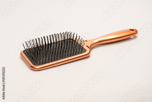 A red hairbrush isolated on a white background. Hair tools.