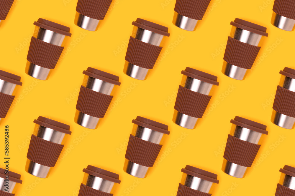 Repetitive pattern made of reusable coffee cup on a yellow background. Take away drinks composition.