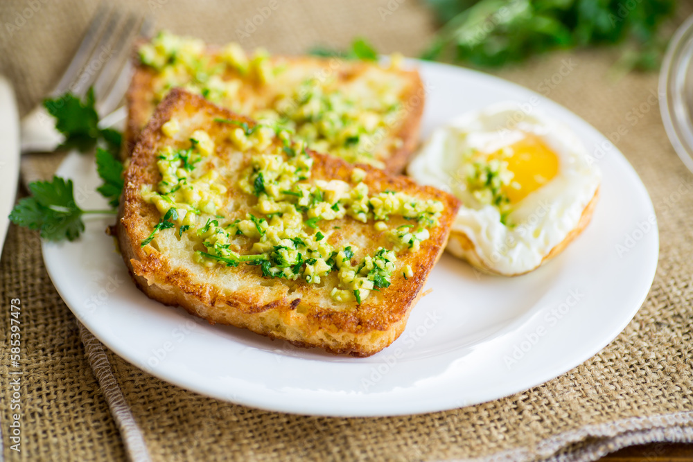 Fried croutons in batter with garlic and herbs in a plate. Fried croutons in batter with garlic and herbs in a plate.