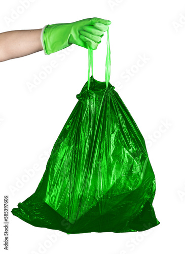 Hand holding green garbage bag with organic waste, trash sack full of biodegradable rubbish isolated on white background