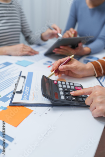 small business accounting team meeting three asian people with salary monthly charts data, basic business accounting and bookkeeping concept.