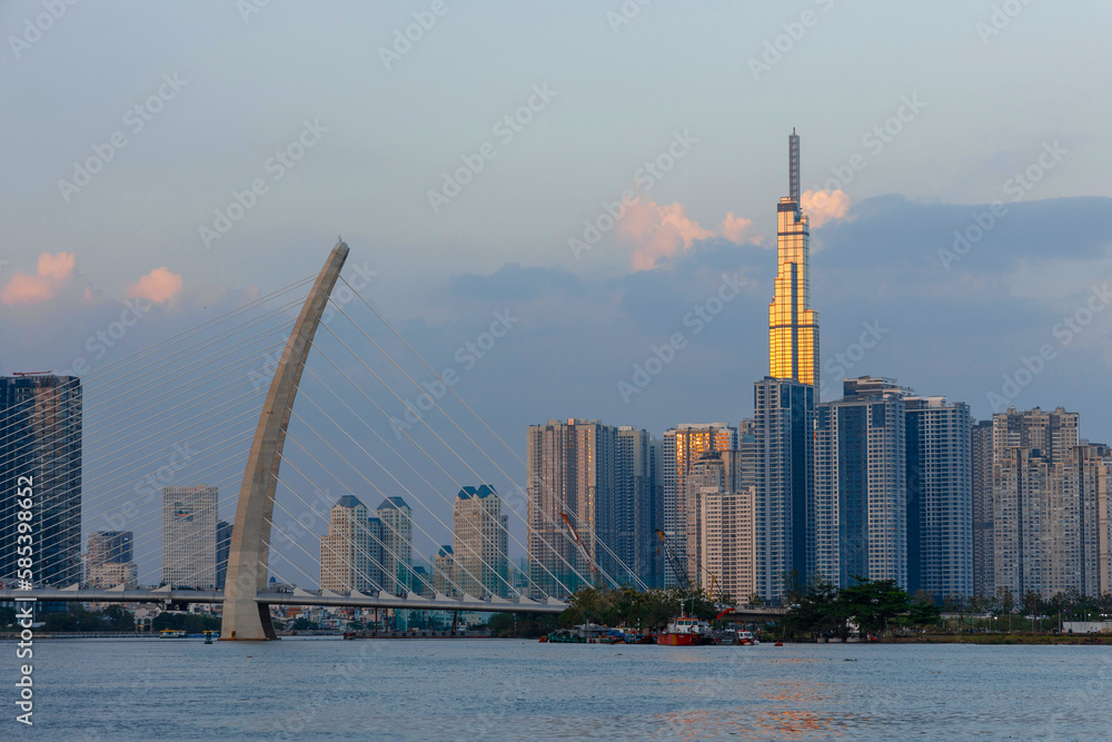 Obraz premium Beautiful sunset at 81 Ho Chi Minh Landmarks, the tallest building in Vietnam and the Cau Ba Son Bridge