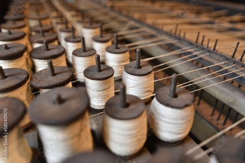 Fototapeta Naklejka Na Ścianę i Meble -  Dozens of spools of thread at an old textile mill.
