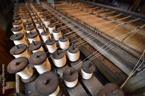 Fotografija Dozens of spools of thread in an old textile mill