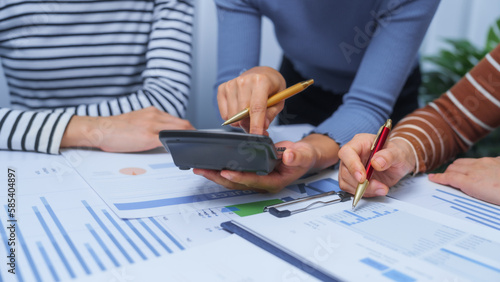 Fotografie Using calculator, small business accounting team meeting three asian people with salary monthly charts data, basic business accounting and bookkeeping concept