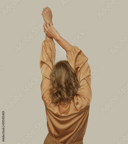 Serie of studio photos of young female model wearing golden beige silk long sleeved blouse