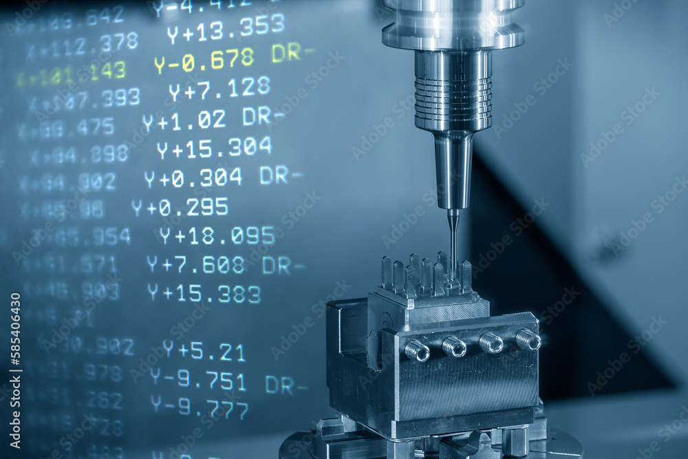 abstract scene the CNC milling machine cutting the copper electrode parts and G-code data background. abstract scene the CNC milling machine cutting the copper electrode parts and G-code data background.