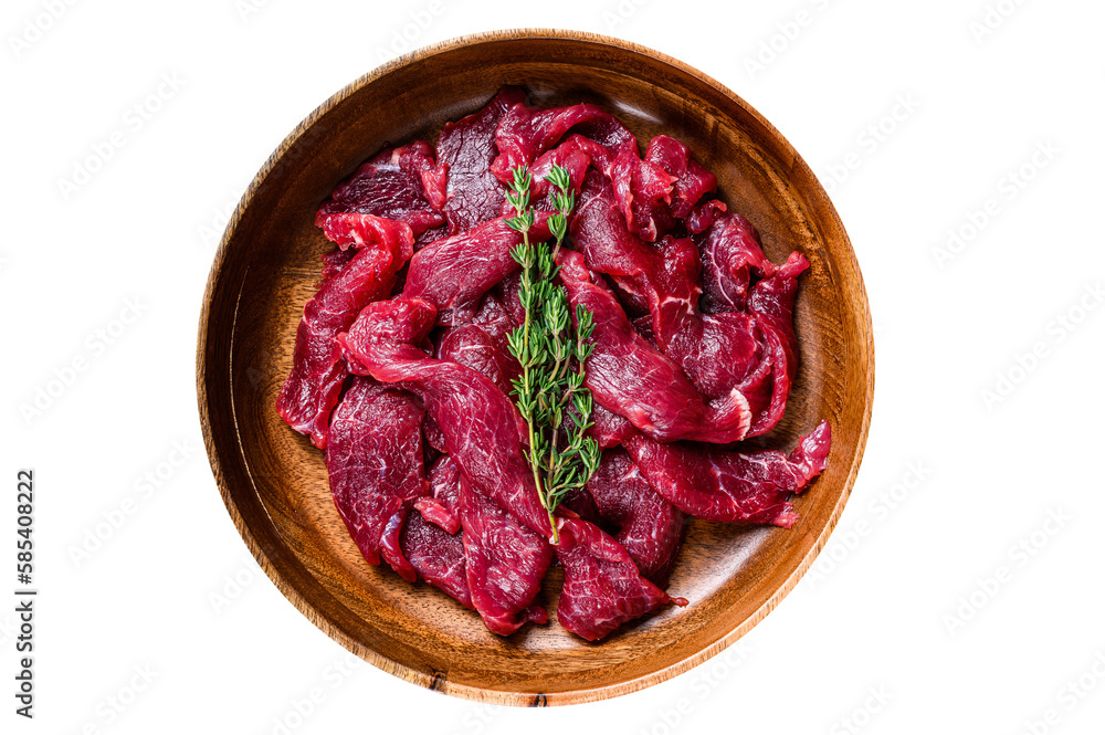 Raw uncooked beef meat sliced in strips with fresh herbs for beef stroganoff.  Isolated, transparent background.