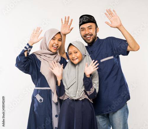 beautiful asian family with daughter wearing traditional islamic clothes over white background