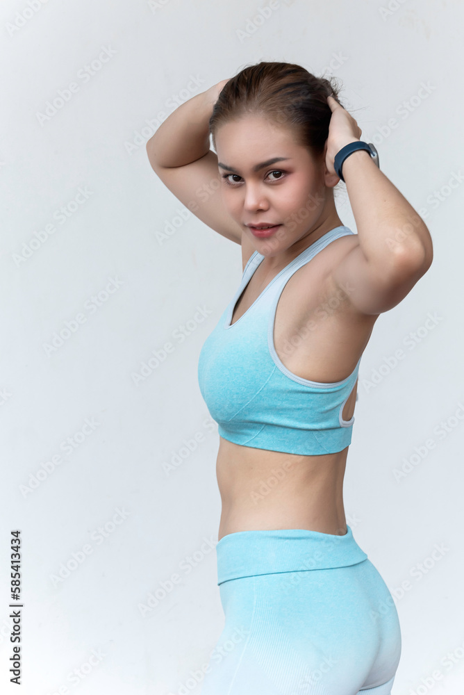 Woman exercise in yoga style and image of fitness. Woman in sport clothing with muscular body. Concept of healthy lifestyle.