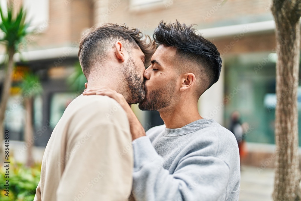 Young couple hugging each other kissing at street Young couple hugging each other kissing at street
