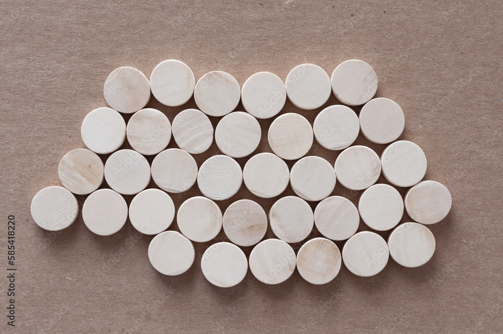 isolated bed of round wooden shapes on cardboard isolated bed of round wooden shapes on cardboard