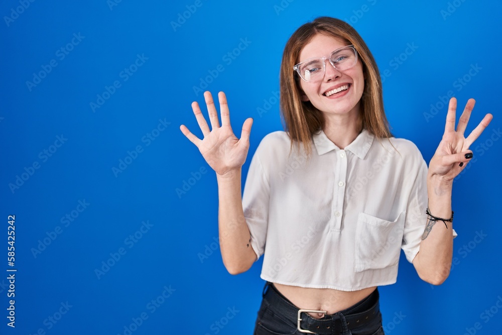 Beautiful woman standing over blue background showing and pointing up with fingers number eight while smiling confident and happy. Beautiful woman standing over blue background showing and pointing up with fingers number eight while smiling confident and happy.