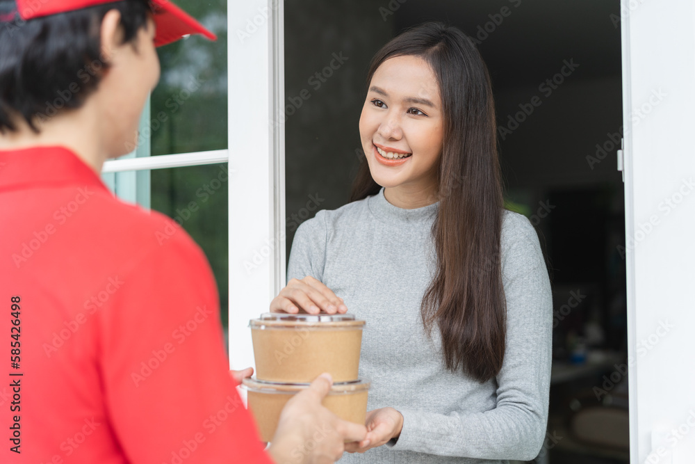 Client receiving lunch box from delivery man at home. Client receiving lunch box from delivery man at home.