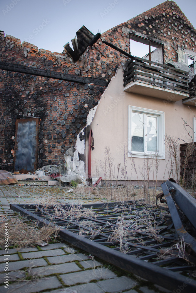 Destroyed building after russian invasion, Ukraine. Ruined facade of house. War in Ukraine. Broken windows and brick walls after missile attack. Abandoned damaged home. War disaster. 