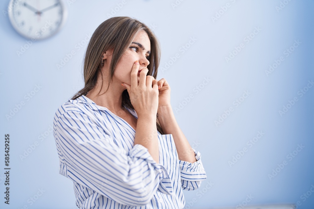 Young woman talking on the smartphone with worried expression at home Young woman talking on the smartphone with worried expression at home