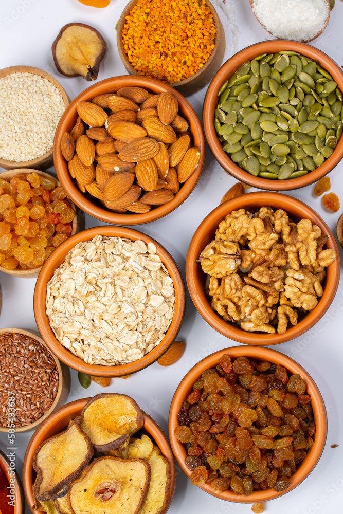 Healthy vegetarian food concept. Assortment of dried fruits, nuts and seeds on white background. Top view. Healthy vegetarian food concept. Assortment of dried fruits, nuts and seeds on white background. Top view.