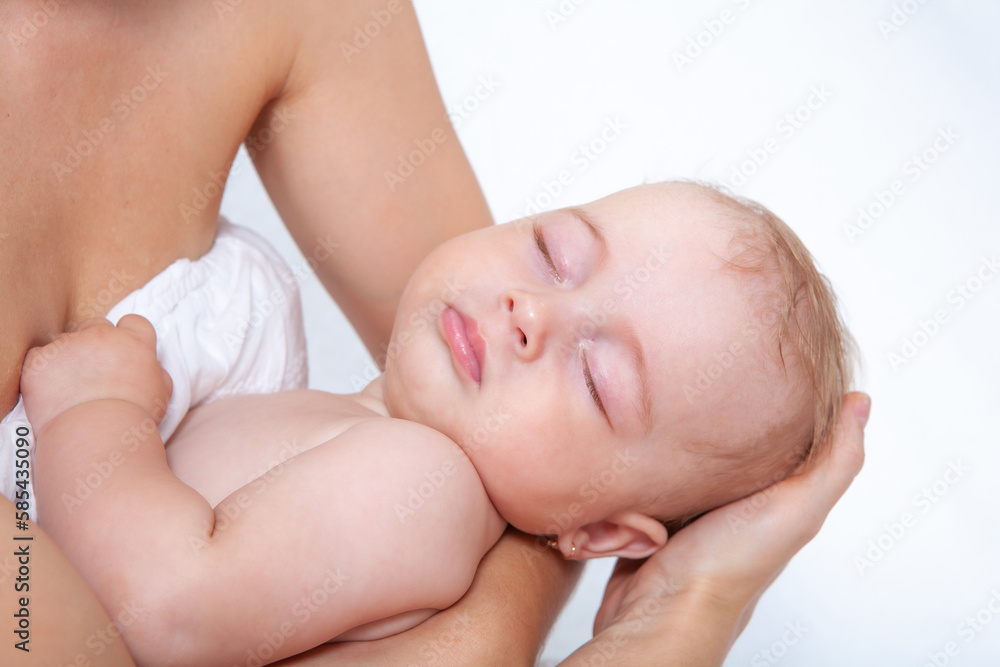baby as leep on hands of mother on a light background baby as leep on hands of mother on a light background