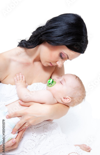baby as leep on hands of mother on a light background photo
