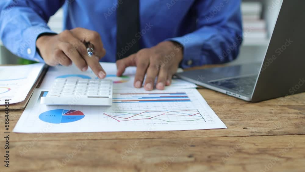 Businessman working with documents and analyzing finances in business report document to plan investment budget. Accounting and Finance Businessman working with documents and analyzing finances in business report document to plan investment budget. Accounting and Finance