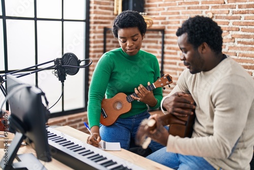 African american man and woman music group compising song at music studio photo