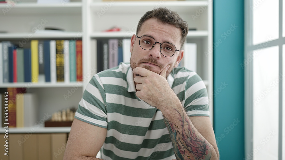 Young caucasian man thinking at library university Young caucasian man thinking at library university