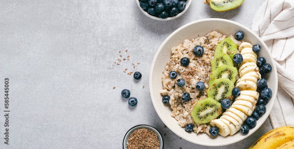 Oatmeal Bowl with Blueberry, Banana and Kiwi, Oat Porridge in a Bowl on Bright Background, Healthy Snack or Breakfast Oatmeal Bowl with Blueberry, Banana and Kiwi, Oat Porridge in a Bowl on Bright Background, Healthy Snack or Breakfast
