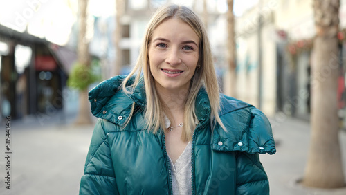 Young blonde woman smiling confident showing braces at street © Krakenimages.com