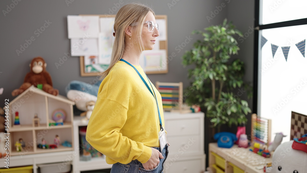 Young blonde woman working as teacher at kindergarten