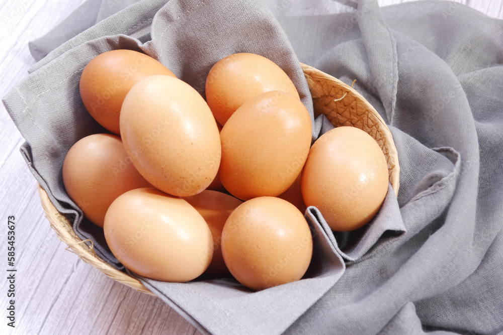 Basket of eggs on a wooden table. Basket of eggs on a wooden table.