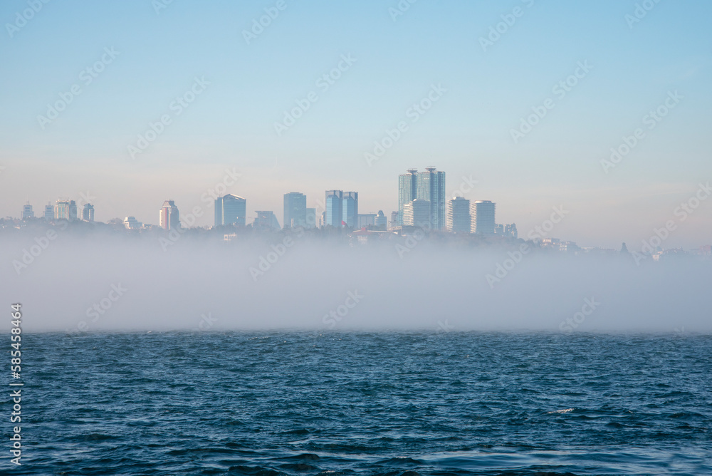 Fog over the Bosphorus Strait, the backdrop to high-rise buildings.