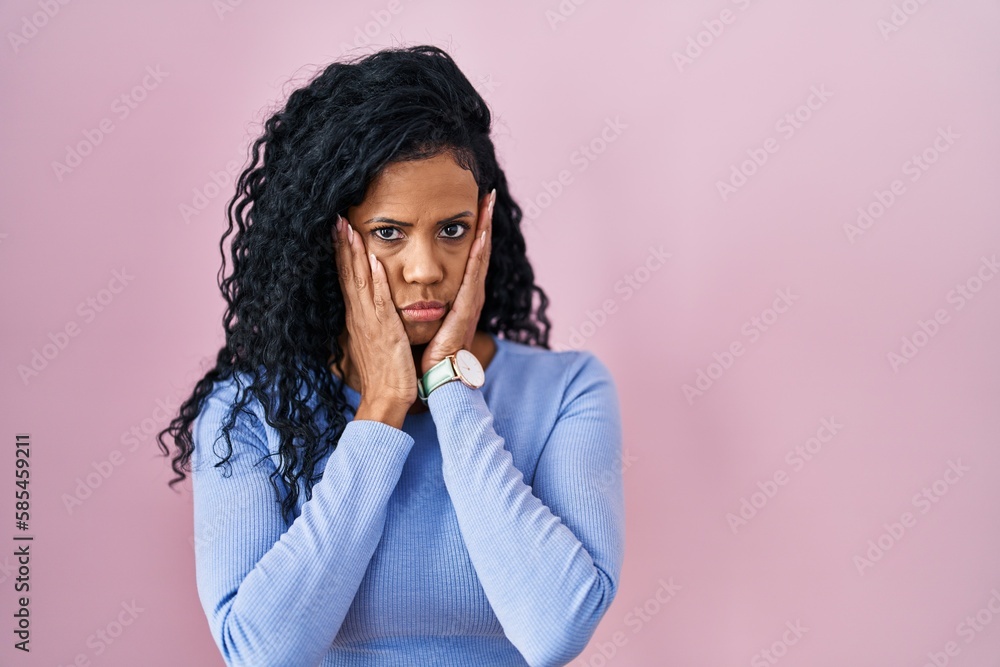 Middle age hispanic woman standing over pink background tired hands covering face, depression and sadness, upset and irritated for problem Middle age hispanic woman standing over pink background tired hands covering face, depression and sadness, upset and irritated for problem