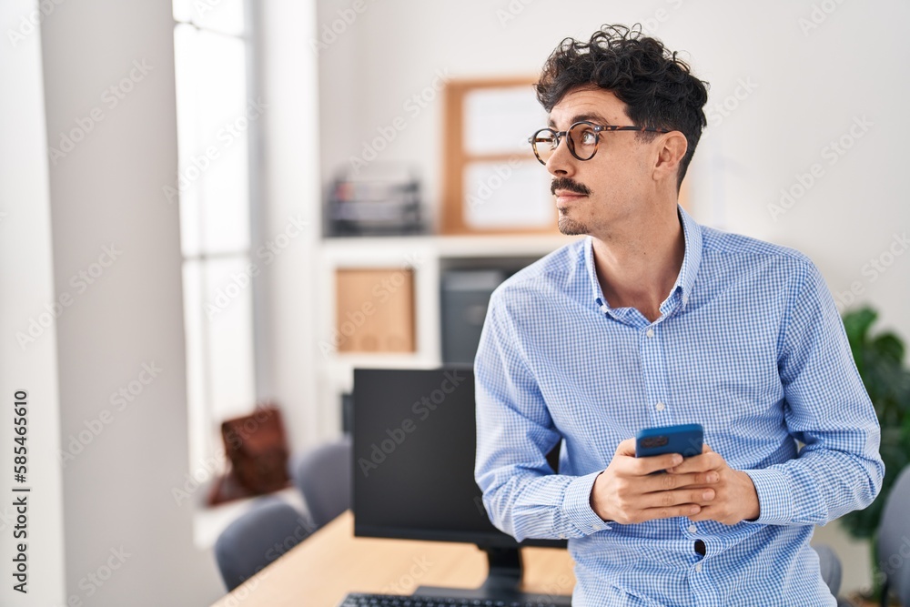 Young caucasian man business worker using smartphone at office Young caucasian man business worker using smartphone at office