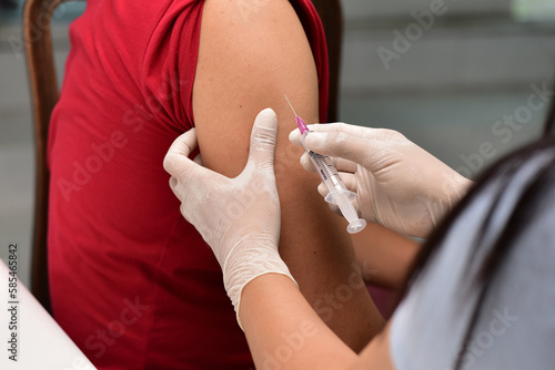 Preventive vaccination The doctor will give the injection to the patient. concept of treatment, prevention, illness