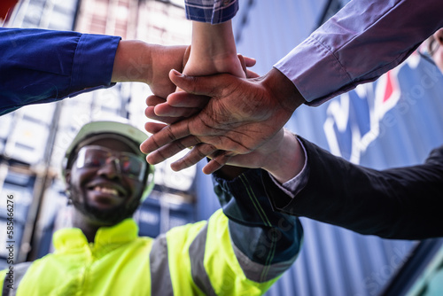 Engineer manager and foreman team joining hands, Workers Join Hand for Collaboration in the container yard.