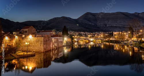 Night cityscape. Trebinje is a city in Bosnia and Herzegovina  the historical center of the city. Buildings are reflected in the river