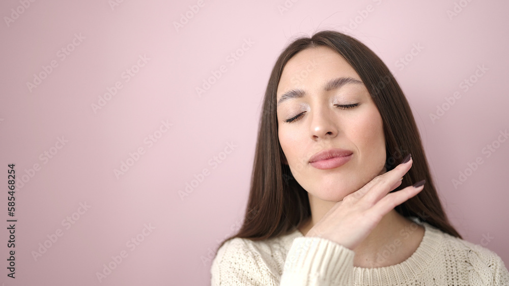 Young beautiful hispanic woman smiling confident touching face over isolated pink background Young beautiful hispanic woman smiling confident touching face over isolated pink background