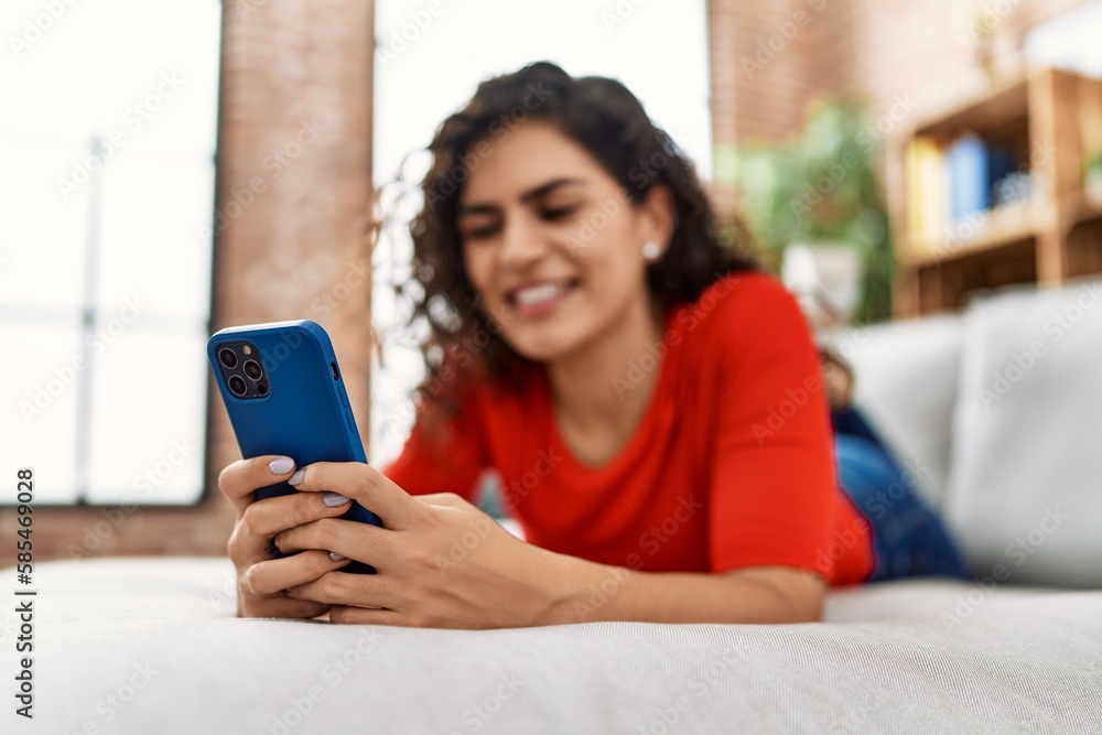 Young latin woman smiling confident using smartphone at home Young latin woman smiling confident using smartphone at home