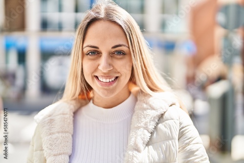 Young woman smiling confident standing at street