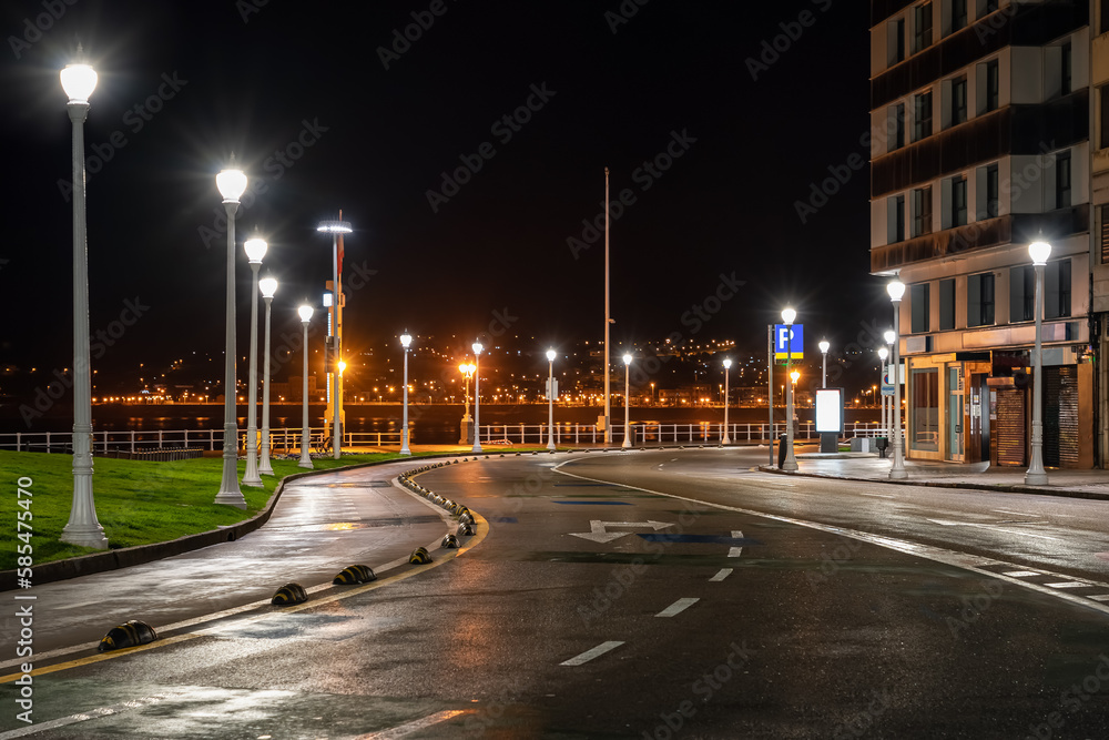 Empty streets next to the promenade of Gijon at night on a rainy day, Asturias.