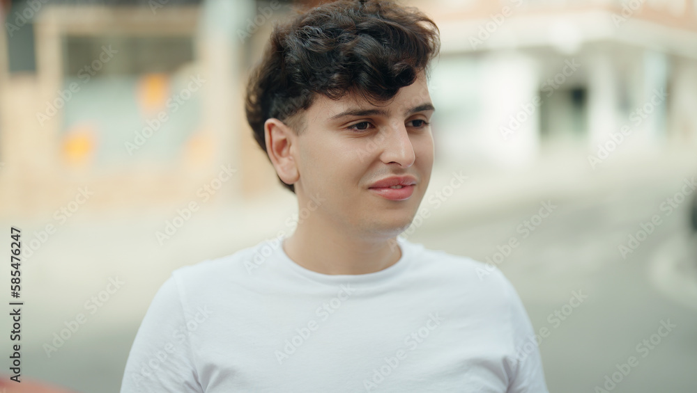 Non binary man smiling confident looking to the side at street Non binary man smiling confident looking to the side at street